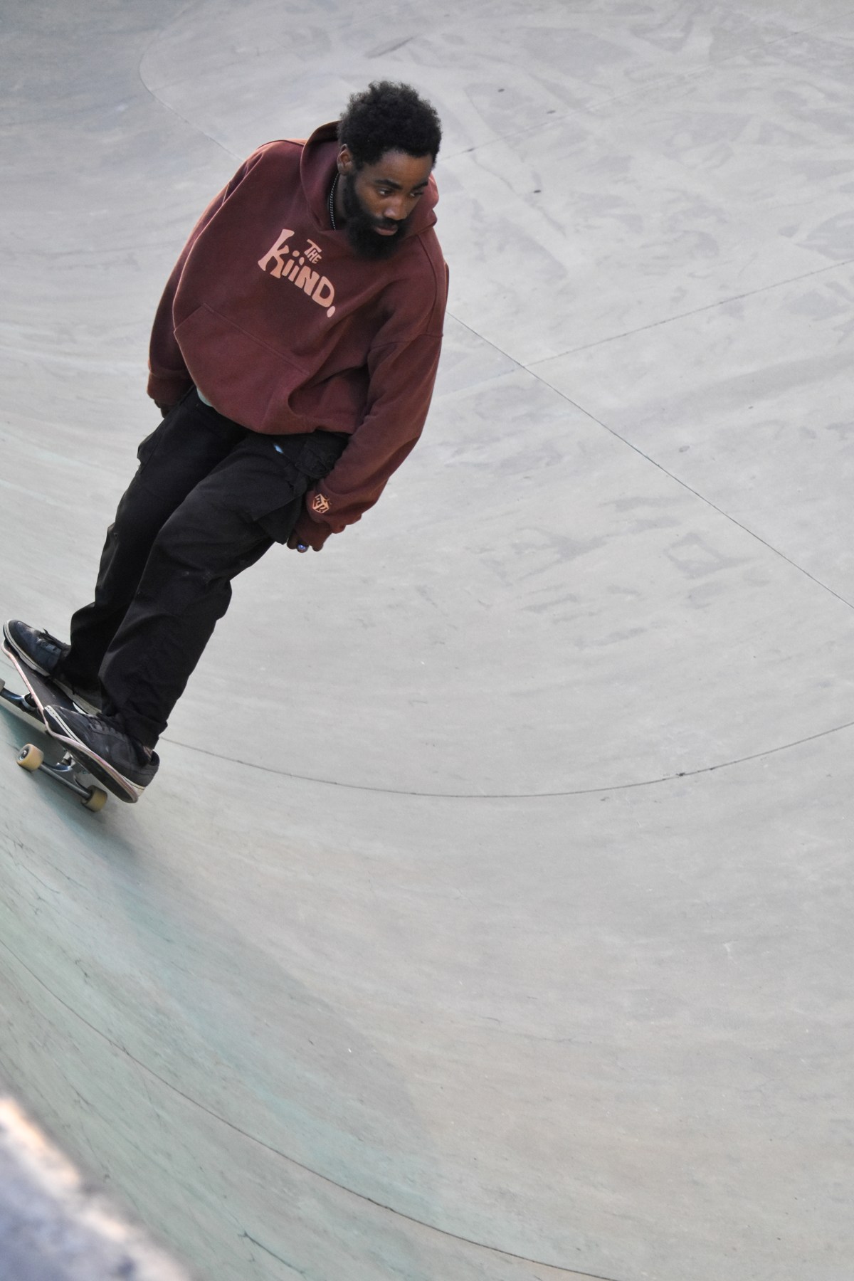 Skateboarder wearing the brown Sleeping Lady hoodie
